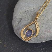 1.06ct Tanzanite & Diamond Swirl Pendant Necklace 9ct Yellow Gold from Ace Jewellery, Leeds