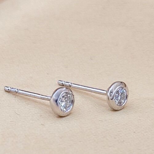 Platinum 0.29ct Collet-Set Diamond Solitaire Stud Earrings from Ace Jewellery, Leeds